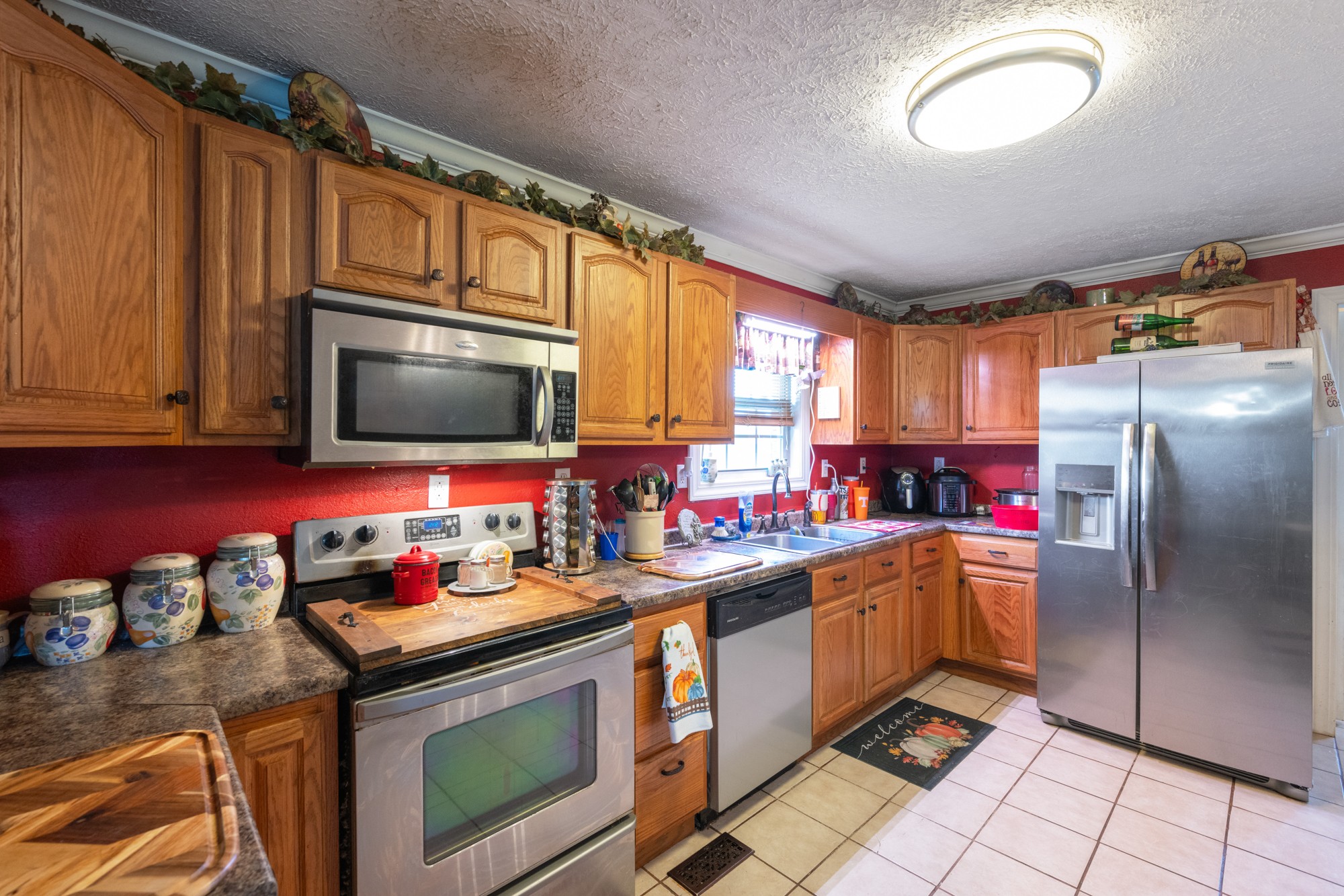 1354 Brandon Road Huntingdon, TN 38344 - Photo 26 of 37 a kitchen with stainless steel appliances granite countertop a stove microwave and sink