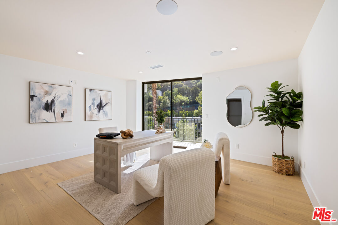 2256 Nichols Canyon Road Los Angeles, CA 90046 - Photo 12 of 45 a living room with furniture a potted plant and a large window