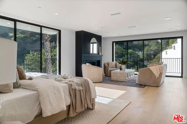 a bedroom with a large bed and a large window