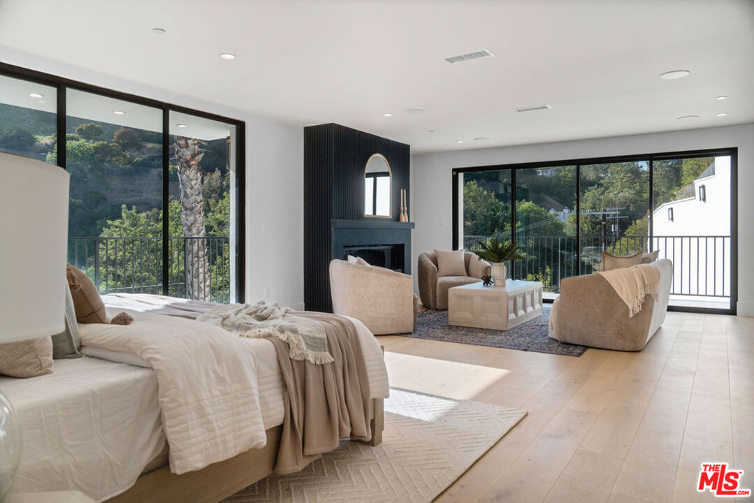 2256 Nichols Canyon Road Los Angeles, CA 90046 - Photo 17 of 45 a bedroom with a large bed and a large window
