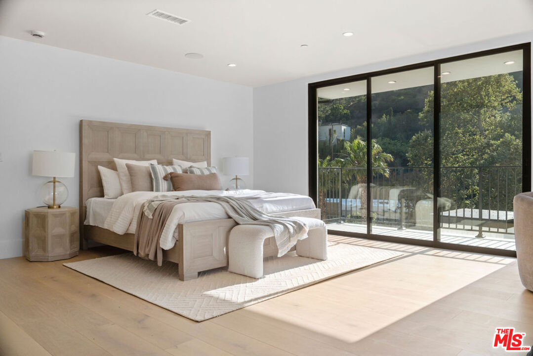 2256 Nichols Canyon Road Los Angeles, CA 90046 - Photo 18 of 45 a bedroom with a large bed and a large window
