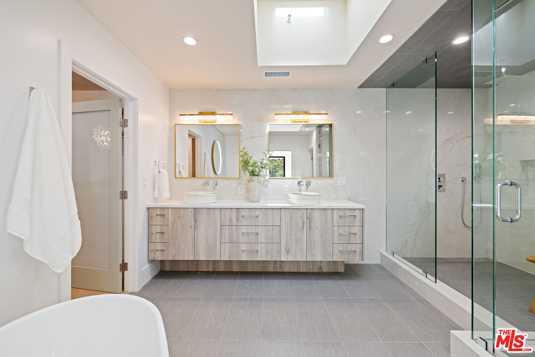 2256 Nichols Canyon Road Los Angeles, CA 90046 - Photo 22 of 45 a bathroom with a double vanity sink mirror and shower