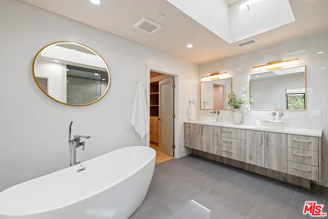 a bathroom with a double vanity sink and a mirror