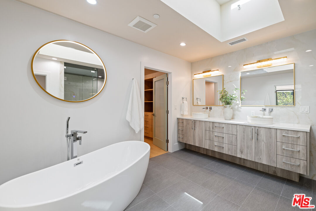 2256 Nichols Canyon Road Los Angeles, CA 90046 - Photo 24 of 45 a bathroom with a double vanity sink and a mirror
