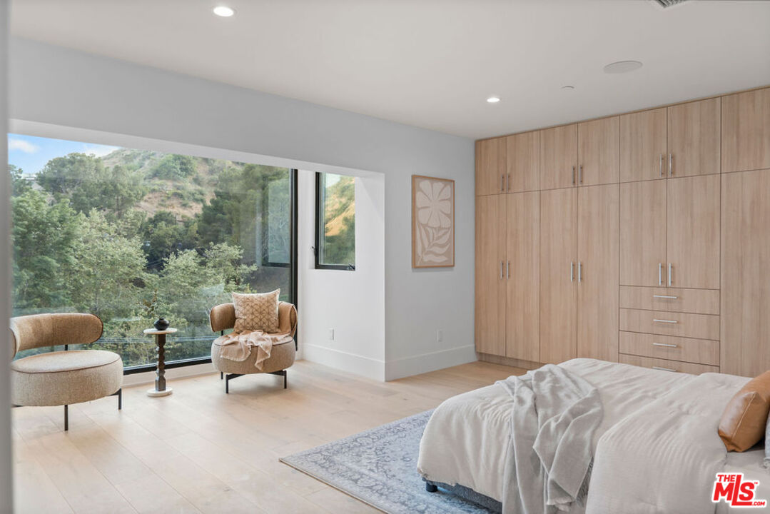 2256 Nichols Canyon Road Los Angeles, CA 90046 - Photo 25 of 45 a bed room with a bed and a couch