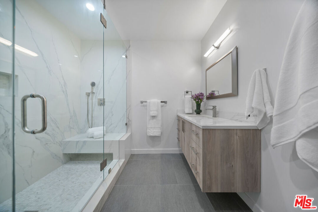 2256 Nichols Canyon Road Los Angeles, CA 90046 - Photo 26 of 45 a bathroom with a double vanity sink a toilet and shower
