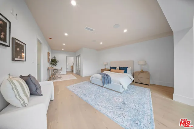 a bedroom with a bed and a couch