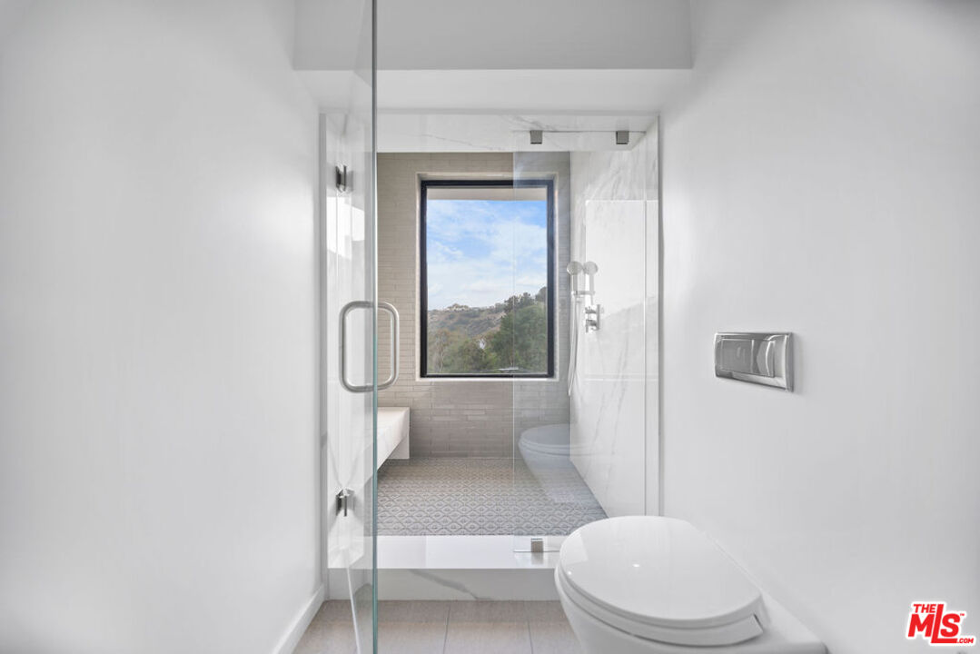 2256 Nichols Canyon Road Los Angeles, CA 90046 - Photo 29 of 45 a white toilet sitting next to a bathroom sink