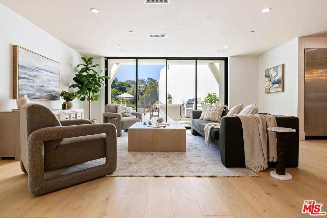 2256 Nichols Canyon Road Los Angeles, CA 90046 - Photo 3 of 45 a living room with furniture large windows and a flat screen tv