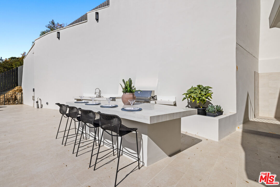 2256 Nichols Canyon Road Los Angeles, CA 90046 - Photo 32 of 45 a view of an outside dining space with a table and chairs
