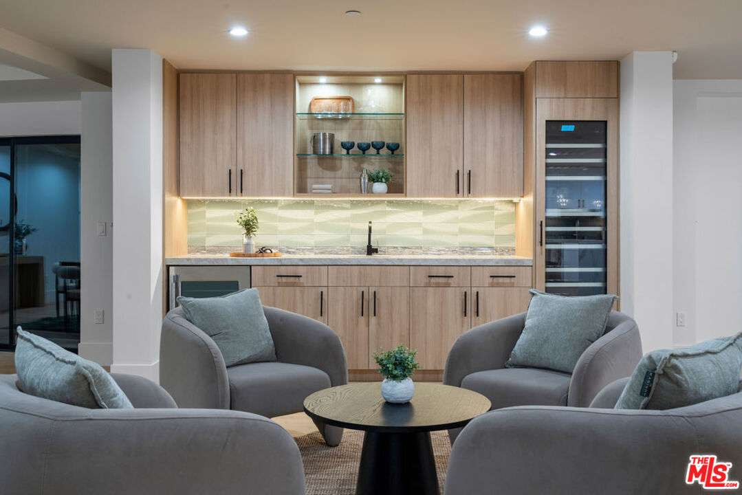2256 Nichols Canyon Road Los Angeles, CA 90046 - Photo 39 of 45 a living room with furniture kitchen view and a potted plant