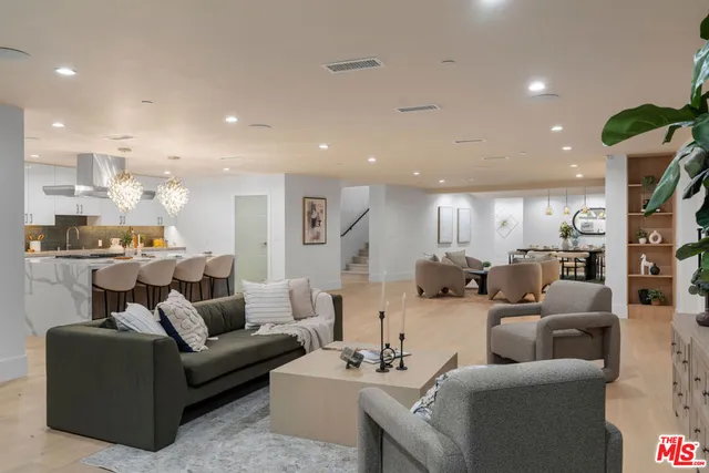 a living room with furniture kitchen view and a table