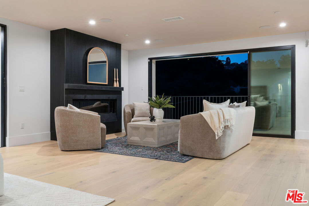 2256 Nichols Canyon Road Los Angeles, CA 90046 - Photo 42 of 45 a living room with furniture and a flat screen tv