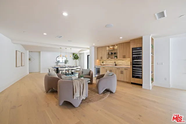 a living room with furniture and a kitchen