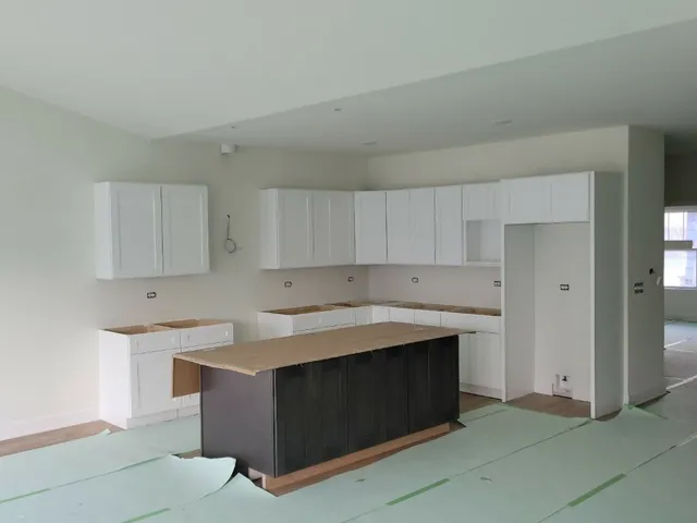 a kitchen with a cabinets and white appliances