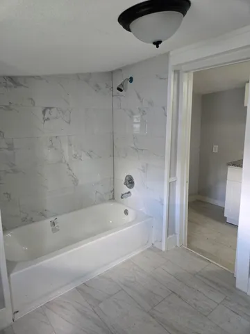 a bathroom with a toilet sink a mirror and vanity