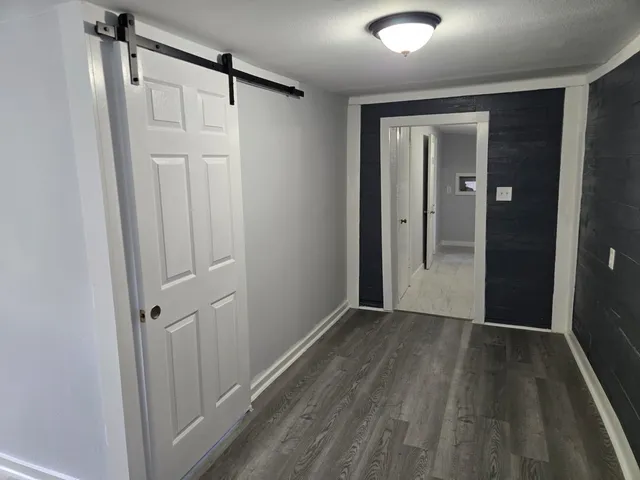 a view of a hallway with wooden floor