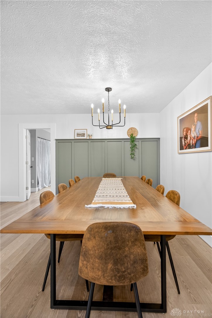 7888 Darke-Preble County Line Road Arcanum, OH 45304 - Photo 13 of 51 This dining room features hardwood flooring and a stylish chandelier, perfect for memorable gatherings.