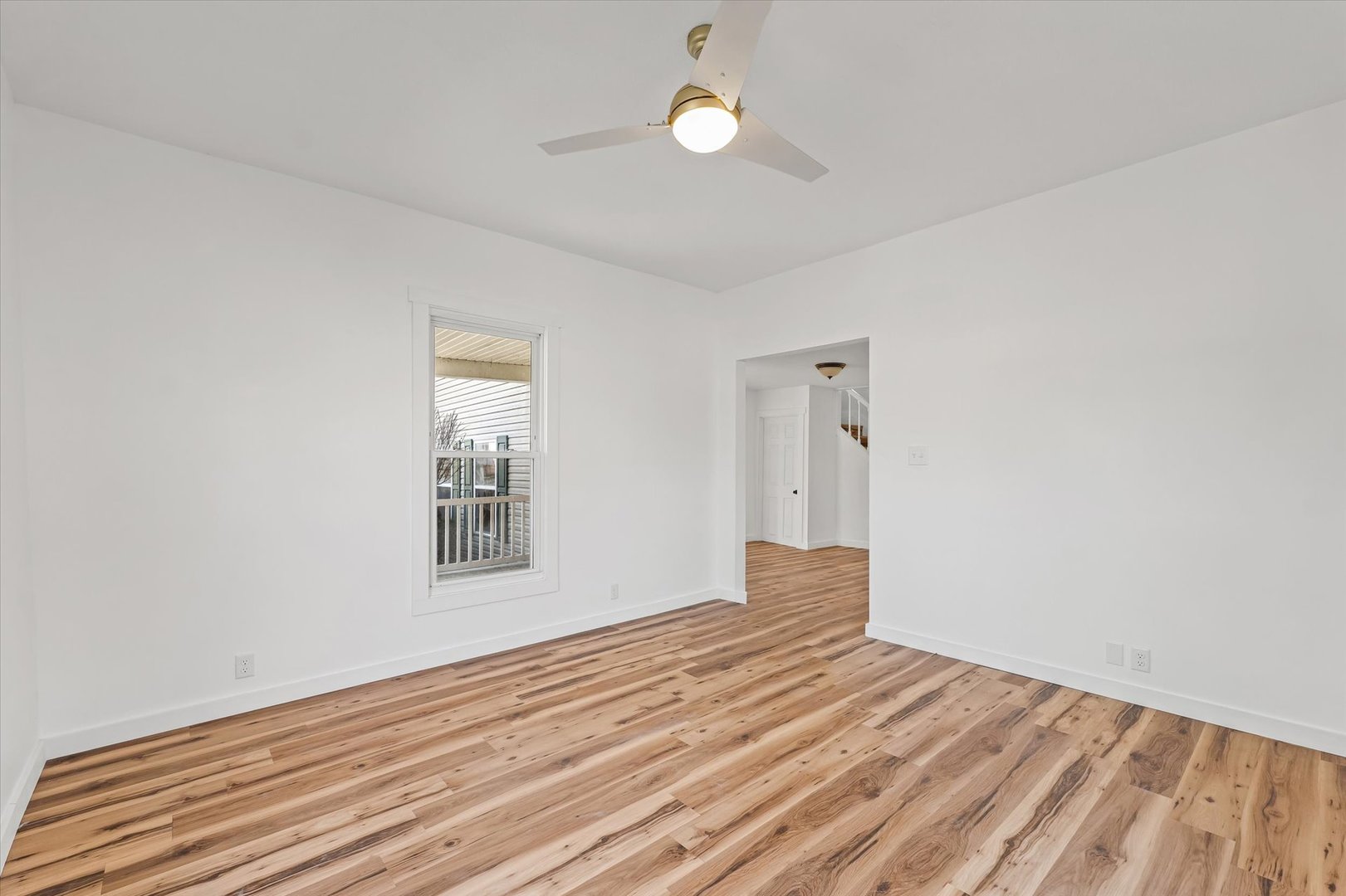 325 North Market Street Hoopeston, IL 60942 - Photo 6 of 35 a view of empty room with wooden floor and fan