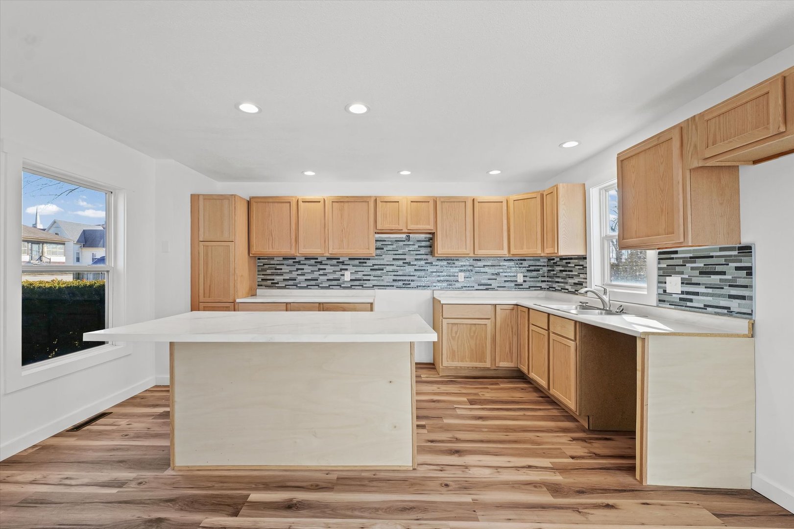 325 North Market Street Hoopeston, IL 60942 - Photo 8 of 35 a kitchen with stainless steel appliances granite countertop a stove top oven a sink dishwasher and a refrigerator with wooden floor