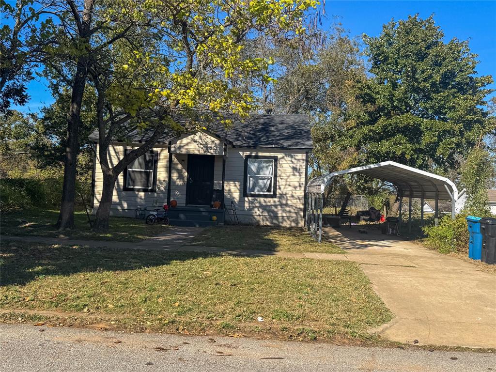 627 East Woodard Street Denison, TX 75021 - Photo 1 of 1 a front view of a house with a yard