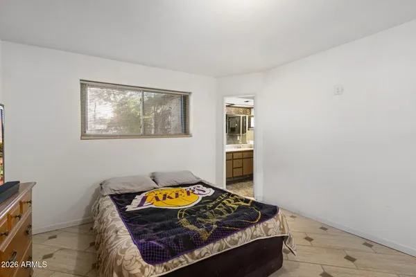 a bedroom with a bed and a dresser in it