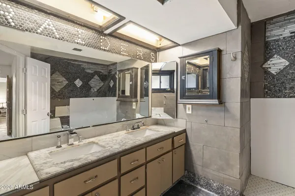 a bedroom with a bed and lamp