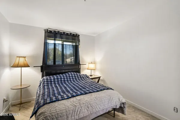 a bed sitting in a bedroom next to a window