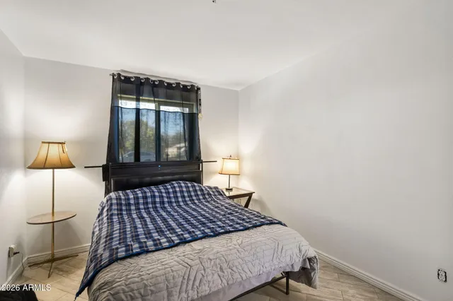 a bed sitting in a bedroom next to a window