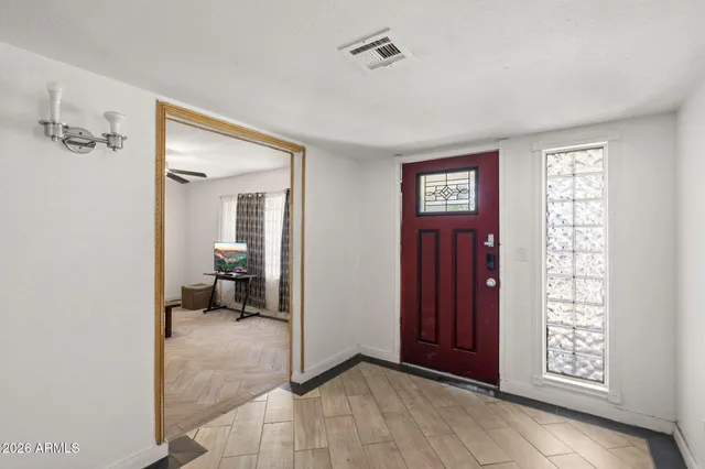 a kitchen with refrigerator and cabinets