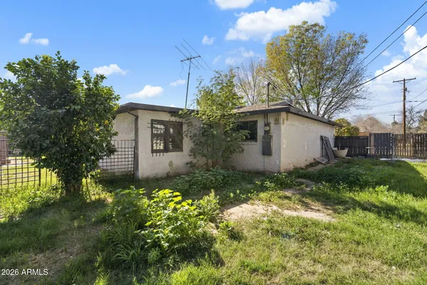 a dining room with furniture a lamp and wooden floor