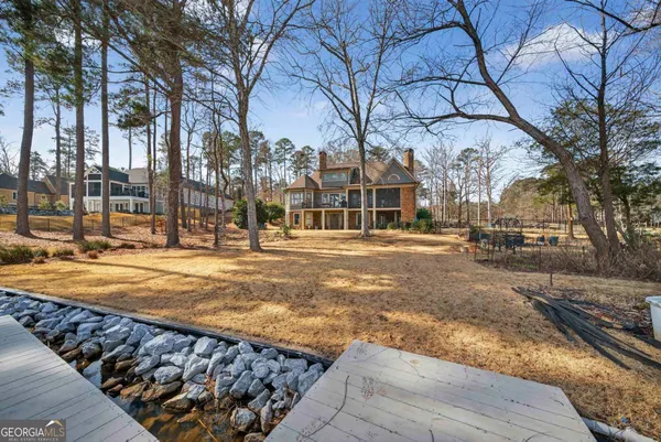 a living room with lots of furniture a wooden floor and a rug