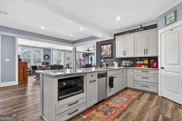 a livingroom with furniture a fireplace and wooden floor