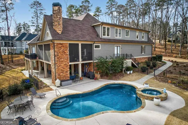 a room with furniture a chandelier a rug and a window