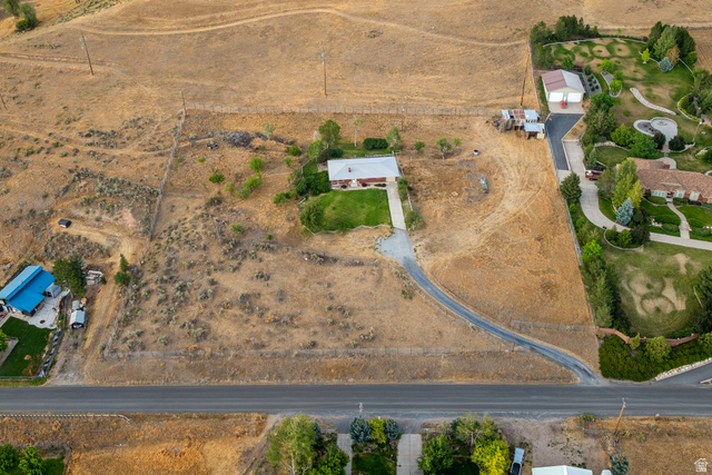 1940 West Old Hwy Road Morgan, UT 84050 - Photo 57 of 73 Property featuring a single-story residence with a light-colored roof, a gravel driveway, and surrounding arid landscaping
