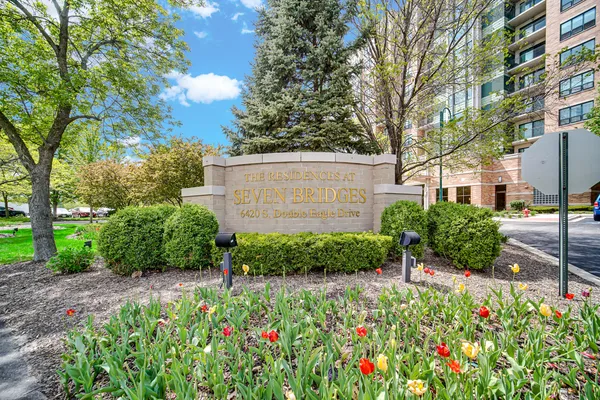 a view of a garden with flowers and trees