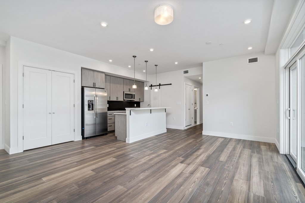 429 Cherry Street, Unit 12 Newton, MA 02465 - Photo 5 of 20 a view of kitchen with stainless steel appliances refrigerator microwave and stove