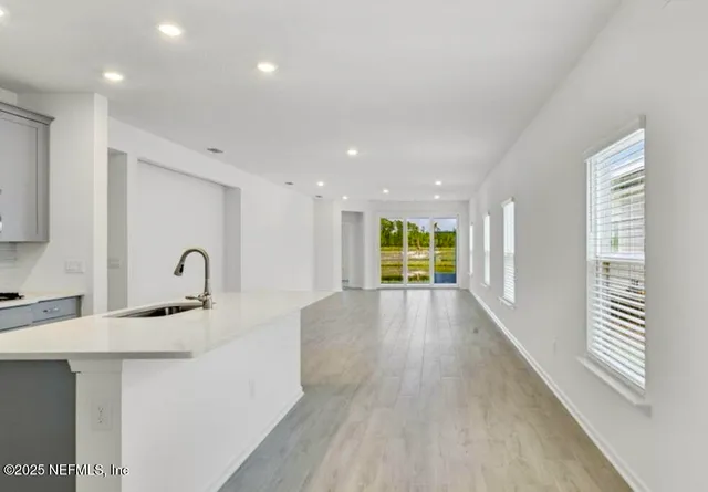 a view of a kitchen with a sink and a window