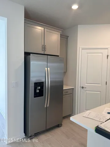 a kitchen with metallic refrigerator freezer and a dishwasher