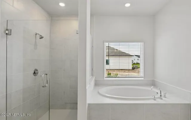 a bathroom with a bathtub and shower
