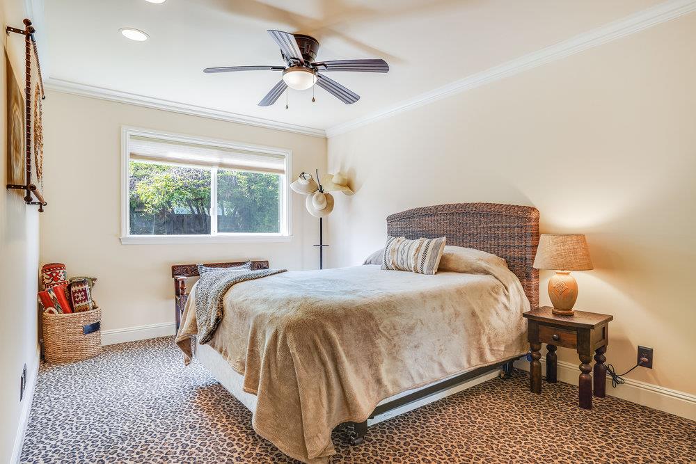 475 Rincon Avenue Sunnyvale, CA 94086 - Photo 28 of 58 a bedroom with a bed and a chandelier