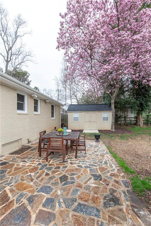 4143 Pineview Road Charlotte, NC 28211 - Photo 19 of 22 a backyard of a house with barbeque oven and outdoor seating