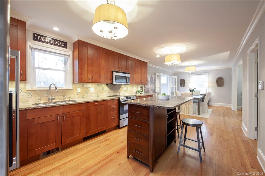 4143 Pineview Road Charlotte, NC 28211 - Photo 5 of 22 a kitchen with a sink cabinets and wooden floor