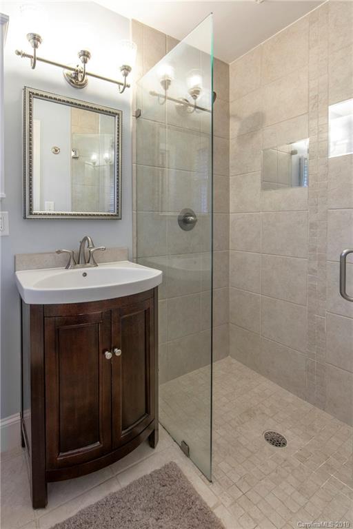 4143 Pineview Road Charlotte, NC 28211 - Photo 10 of 22 a bathroom with a sink a mirror a glass door a shower and vanity
