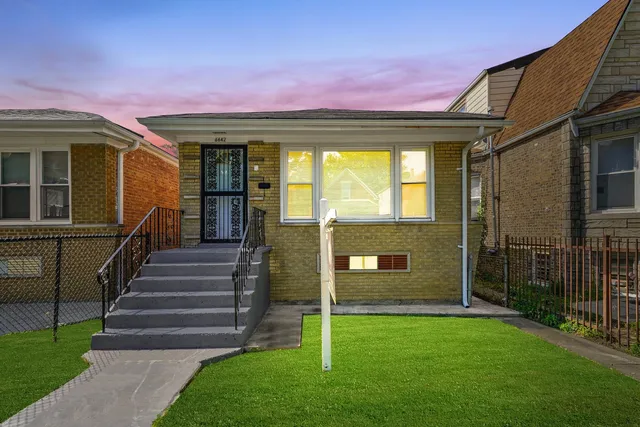 a front view of a house with a garden