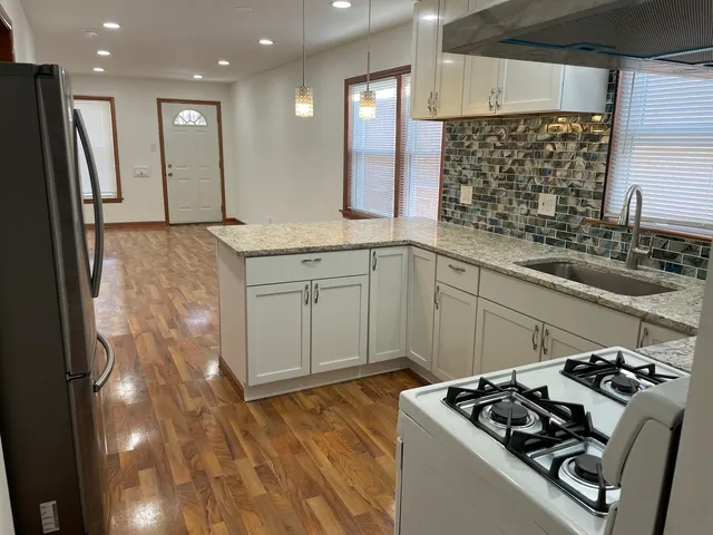 a kitchen that has a sink and a stove