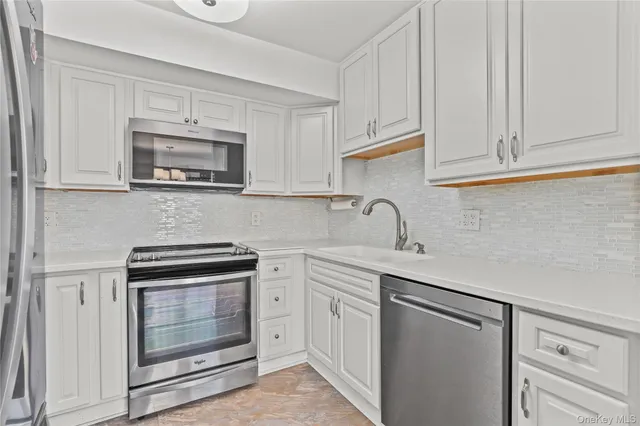 a bathroom with a sink vanity mirror and toilet