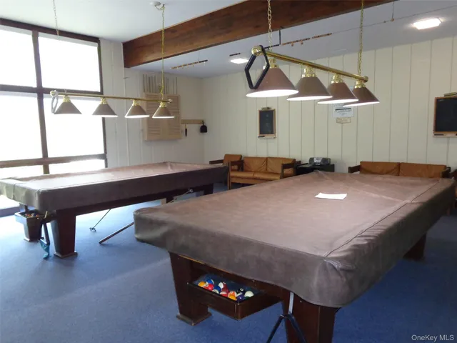 a dinning table and chairs in a room with a chandelier