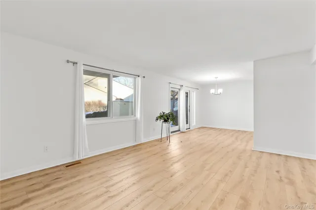 a view of an empty room and wooden floor
