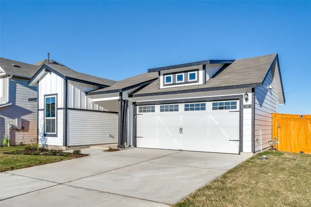 a front view of a house with a garage